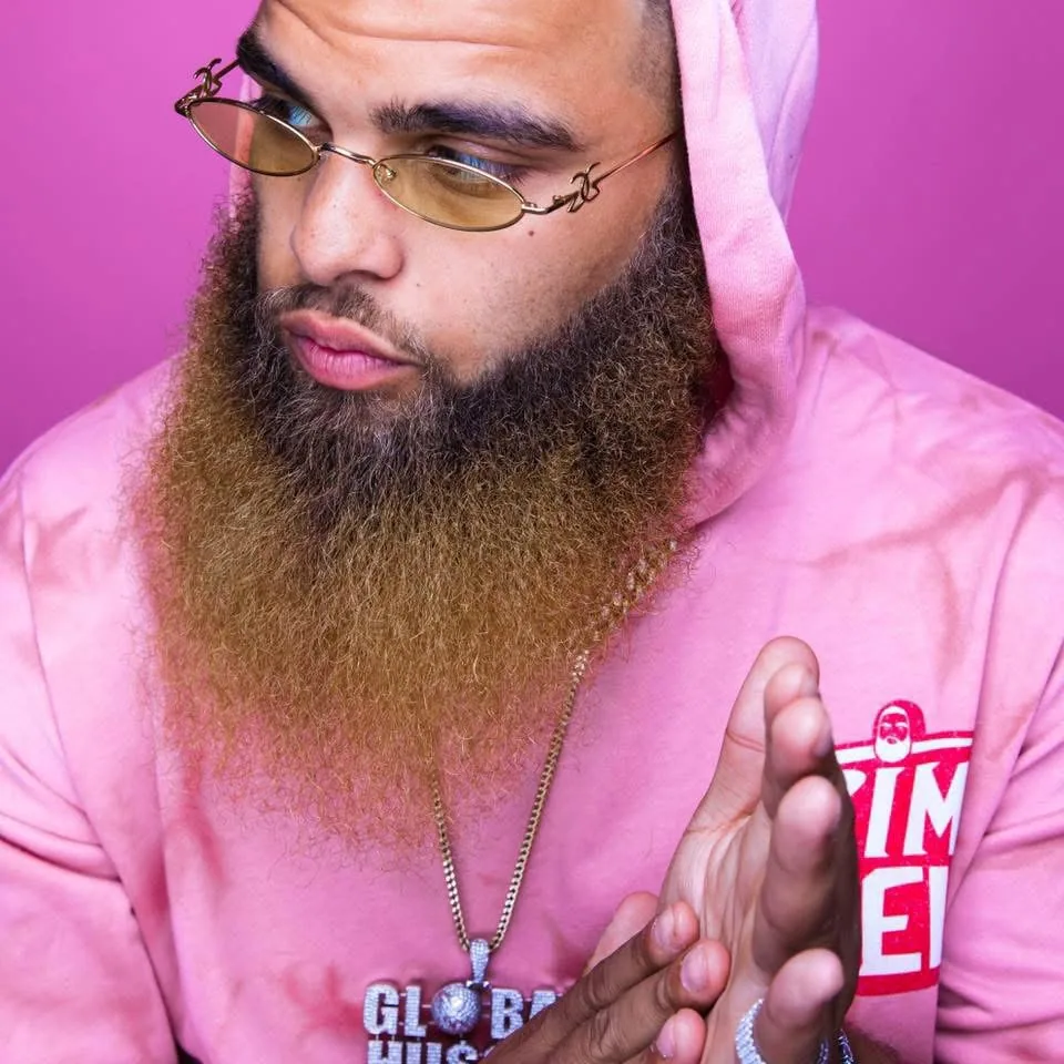 Coach Crim in a pink hoodie from his rap days